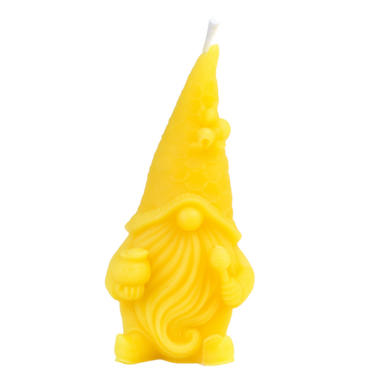 Yellow gnome-shaped candle on a white background