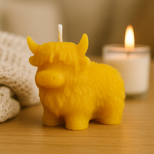 Handcrafted Highland Cow beeswax candle by Newton Honey, 6cm tall, made from pure beeswax, rustic and eco-friendly Scottish decor.