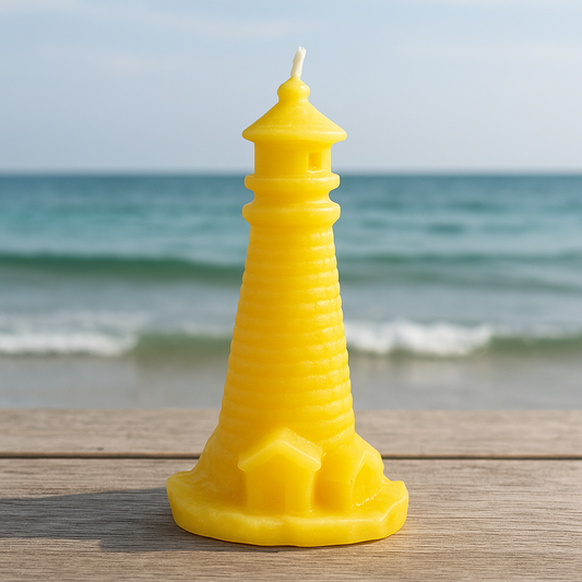 Yellow beehive-shaped beeswax candle on a wooden surface with a beach background
