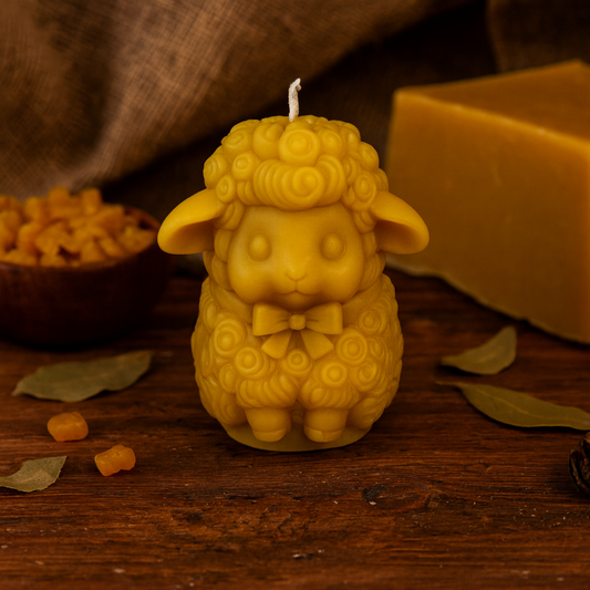 Handcrafted sheep-shaped beeswax candle with detailed curls made from pure beeswax.