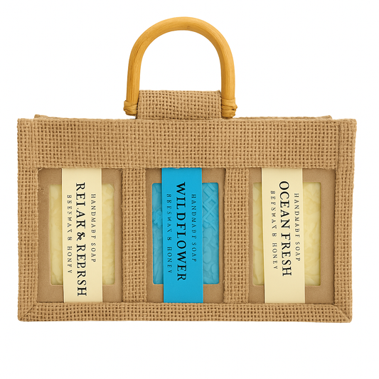 A handcrafted jute gift bag containing three natural beeswax and honey soaps — Relax & Refresh, Wildflower, and Ocean Fresh — ideal for gifting.