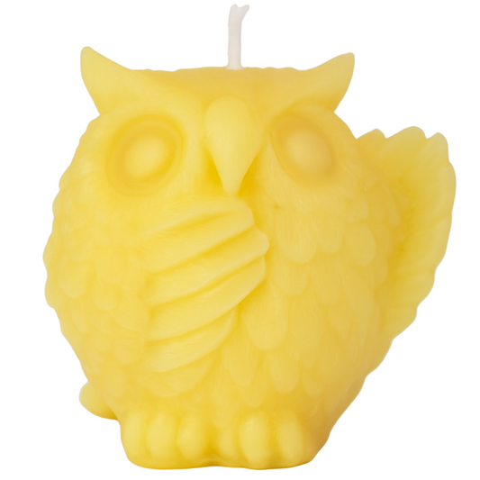 Yellow owl-shaped candle on a white background