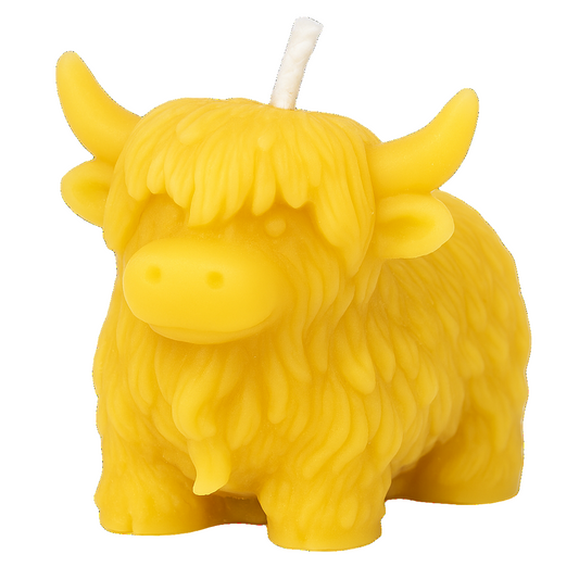 Highland cow-shaped beeswax candle on a white background